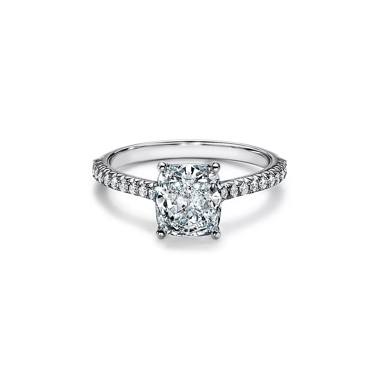 Tiffany & Co. Tiffany Novo® cushion-cut engagement ring with a pavé diamond band in platinum. | ^ Engagement Rings